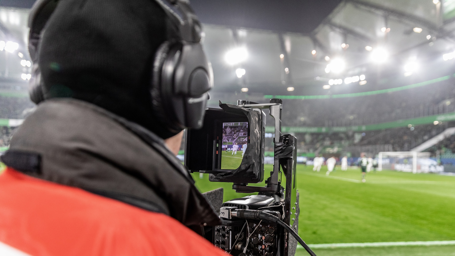 PrimeBug broadcast camera operator filming a live soccer match.